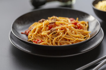 Delicious spaghetti with Bolognese sauce served on a black plate
