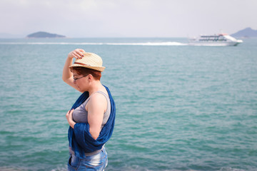 Windy summer days relaxing on coast feeling good. adult woman in glasses and jeans walks on the coast