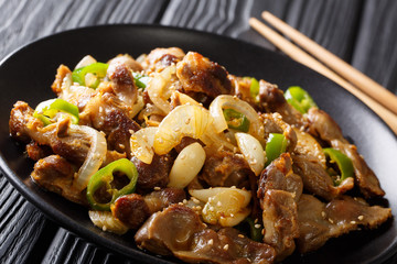 dak-ttongjip-bokkeum hicken gizzard with onions, garlic, chili and sesame close-up. horizontal