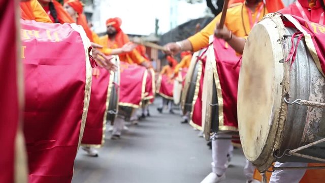 Hands of boys and girls playing Indian drums, Dhol, during Ganesh Festival in Pune, Maharashtra, India.