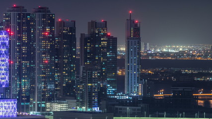 Aerial skyline of Abu Dhabi city centre from above night timelapse