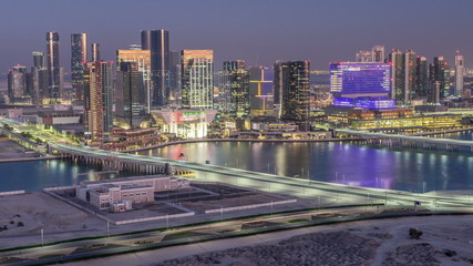 Aerial skyline of Abu Dhabi city centre from above day to night timelapse