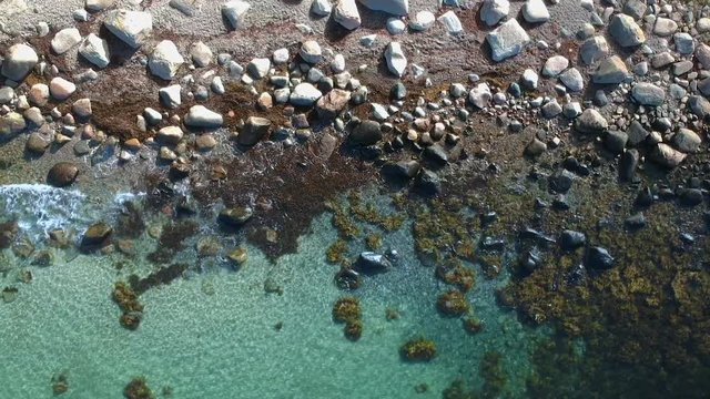 Aerial drone shot of a rocky beach ocean coastline on the west coast of Sweden in Halland, outside of Gothenburg.