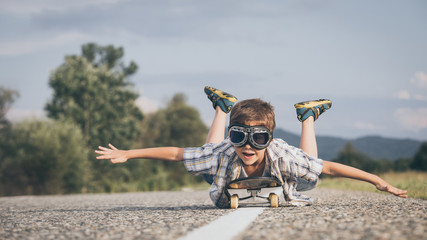 Happy little boy playing on the road at the day time. - obrazy, fototapety, plakaty