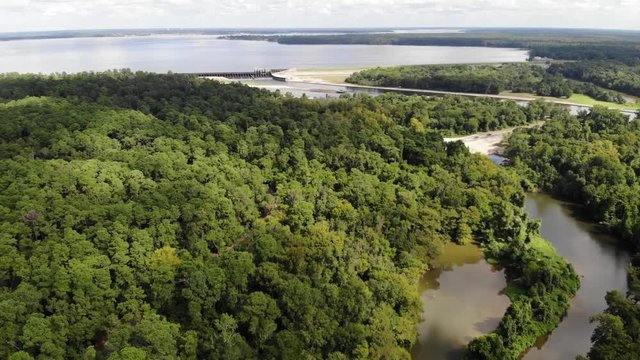 Aerial pan left of Lake Houston, dam, San Jacinto River, and the forest