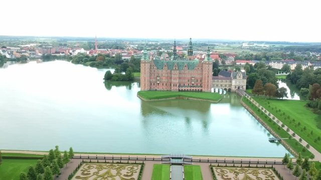 Aerial shot over an opulent garden and castle in Hillerod Denmark