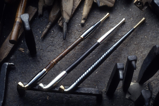 Handmade pipes on workbench