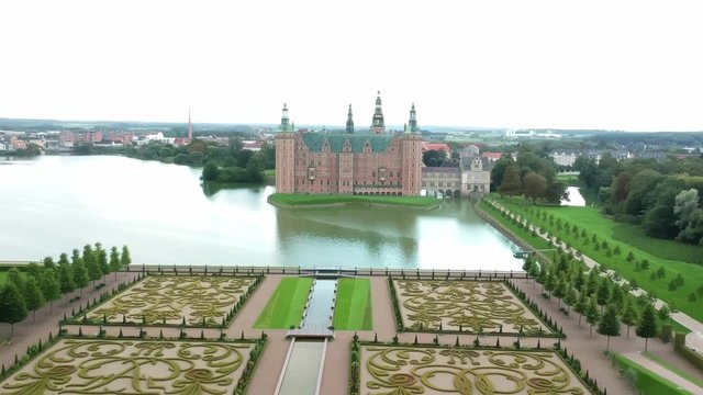 Aerial shot over an opulent garden and castle in Hillerod Denmark