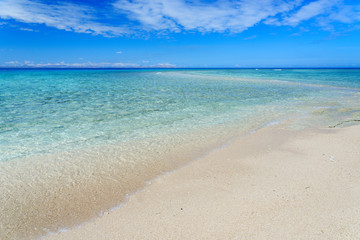 Fototapeta na wymiar White sandy beach on a small Pacific Island
