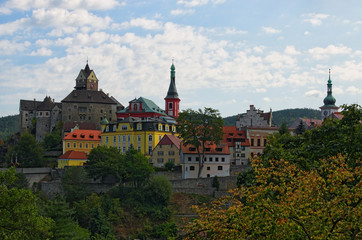 Picturesque landscape view of ancient Loket Castle with colorful buildings by summer sunny day. Bohemia, Sokolov, Karlovarsky Region, Czech Republic
