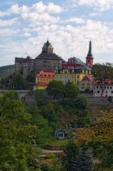 Scenic landscape view of medieval Loket Castle with colorful buildings by summer sunny day. Bohemia, Sokolov, Karlovarsky Region, Czech Republic