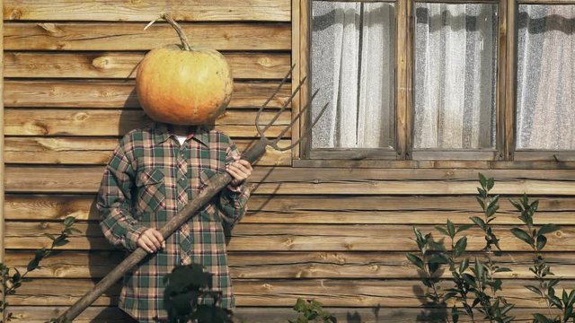 Pumpkinhead person with pitchfork