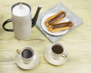 Two cups of coffee and cakes.