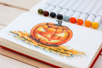 Sketch drawing by markers in sketchbook Halloween Pumpkin