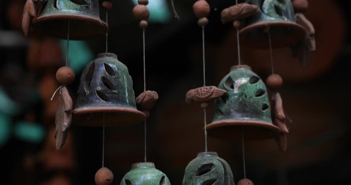 Old Clay Wind Chime moving with breeze in Pune, Maharashtra, India.