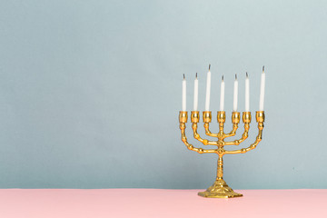 Bronze Hanukkah menorah with burning candles