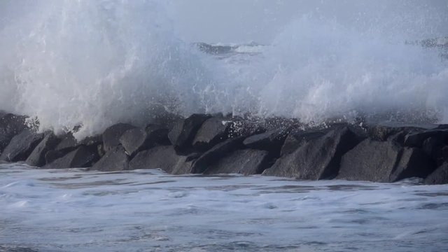 Waves rolling on the beach is a stormy day, winter mediterranean sea. Focene, Lazio, Italy. Slow motion