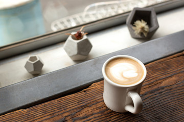 Naklejka na ściany i meble Cup of coffee near the window