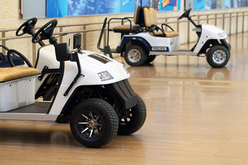 Passenger Utility golf car for Airport. Police golf-?ar at the airport. Electric cars for luggage at the airport