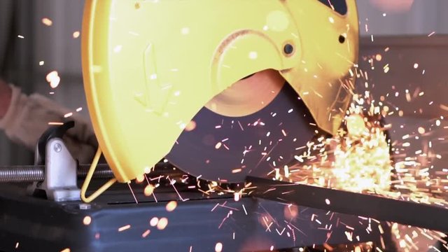 Slow motion of male using chop saw