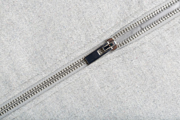 silver zip on woolen fabric © AnnaFotyma