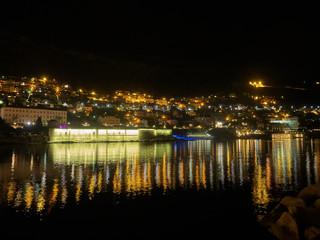 Fototapeta na wymiar Dubrovnik city lights reflecting into water