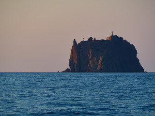 View at sunset of the little island near Stromboli volcano, with its characteristic horse head like rock