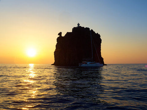 View at sunset of the little island near Stromboli volcano, with its characteristic horse head like rock