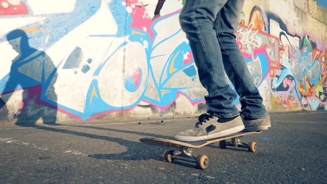A skateboarder rides a skate, slow motion, steadicam shot.