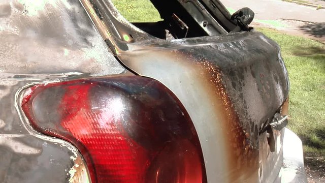 The Car After the Fire. Burnt Out Car With an Open Hood. Engine Burned Out Car Wreck After a Fire. Vandalism.