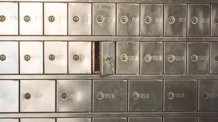 Half opened silver steel post office box (P.O. BOX) with keys inside the lock - obrazy, fototapety, plakaty
