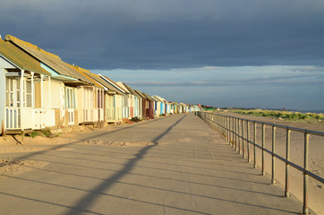 Obraz premium Beach huts with storm clouds