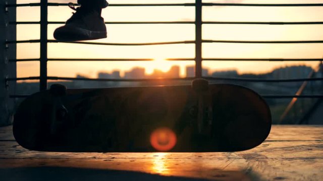 Person doing trick on a skateboard, slow motion.