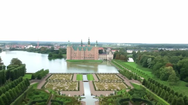 Aerial shot over an opulent garden and castle in Hillerod Denmark
