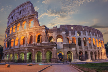 Fototapeta na wymiar Roman Coliseum enlighted in the evening under the clouds