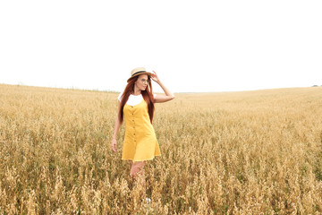 girl with red hair in the autumn field of wheat