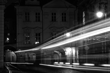 Light trails of a tramway going through the streets of Prague by night