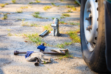 Socket wheel wrench and jack lying on ground