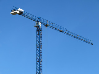Construction crane isolated on clear blue sky background