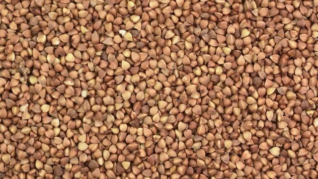 closeup of gluten free buckwheat kasha - rotating background , top view