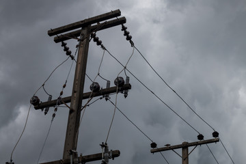 black clouds and electric pole before rainy background