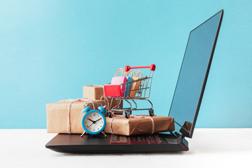 Internet shop / e-commerce sale and delivery service concept: shopping cart multicolored packages...