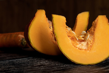 Sliced pumpkin on dark wood