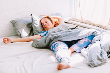 Young woman sleeping in the bed in the morning