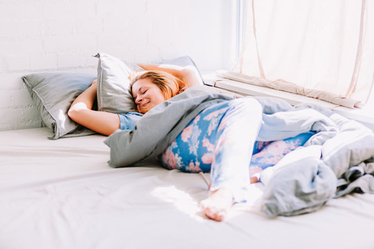 Young woman sleeping in the bed in the morning