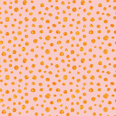 Hand Drawn seamless pattern with gold painted dots. Gift wrap, print, cloth, cute background for a card. Golden dots on pink background. Yellow gold glitter sparkling shiny.