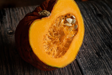 Sliced pumpkin on dark wood