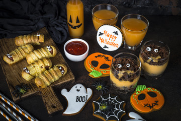 Halloween food assortment - sasage mummies, pumpkin dessert, gin