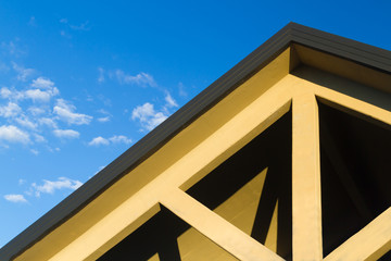 House roof top with blue sky in background
