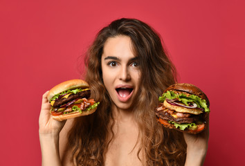 Woman hold two big beef burger sandwich and huge cheeseburger comparing with hungry mouth happy...